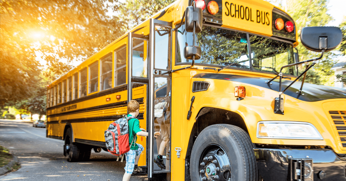 Elementary aged child boarding a school bus