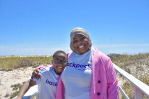 A photo of a child and a woman wearing Backpack Healthcare shirts. 