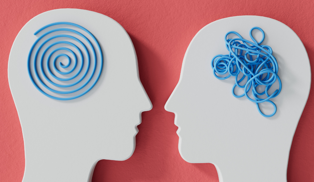 Two silhouette heads looking at each other. The brain of the one on the left is a clean spiral, the brain of the one on the right is a clean spiral jumbled mess.